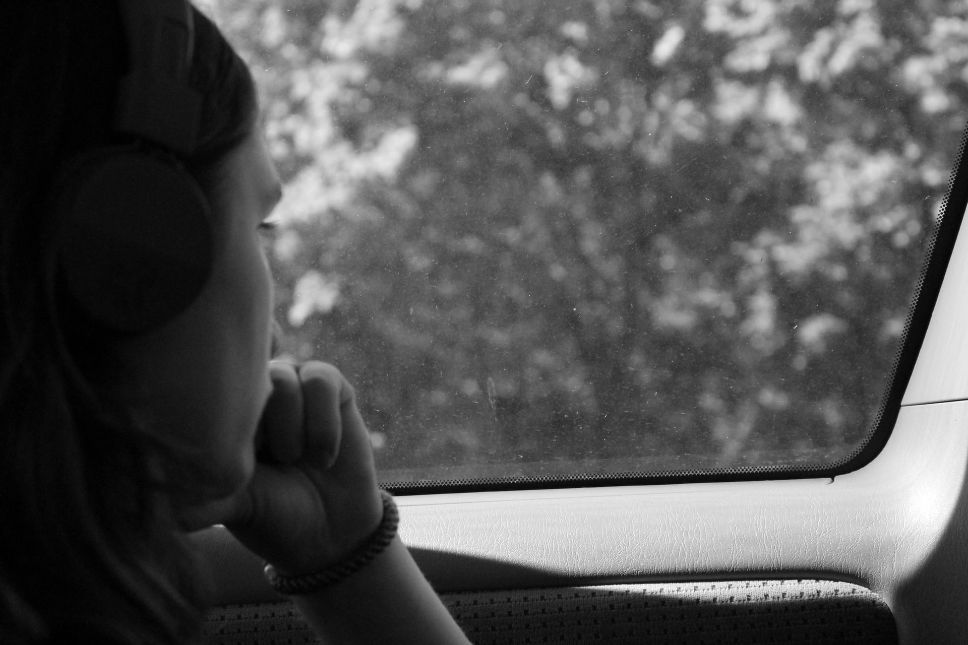 Woman looking out car window