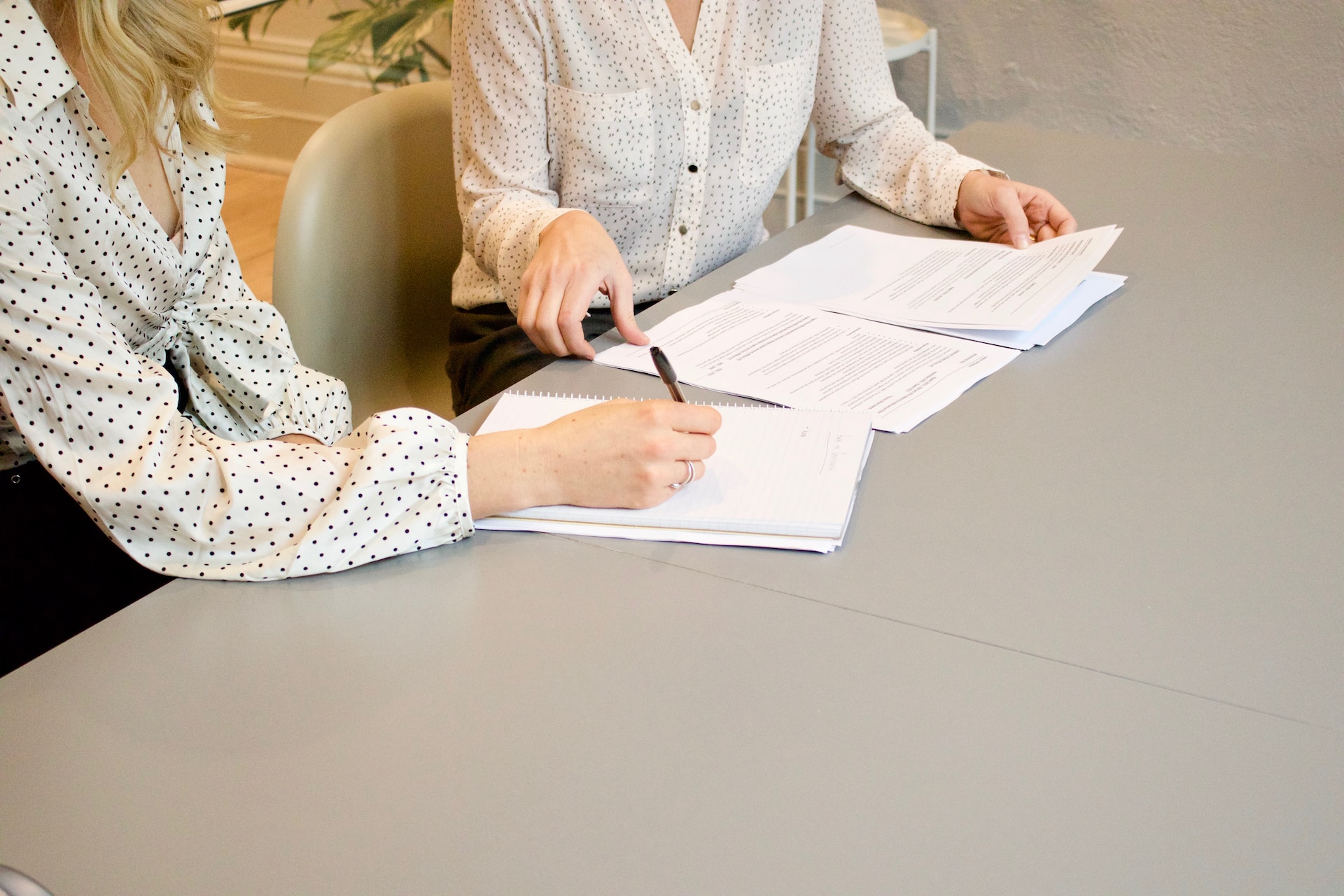woman signing document representing arbitration agreement