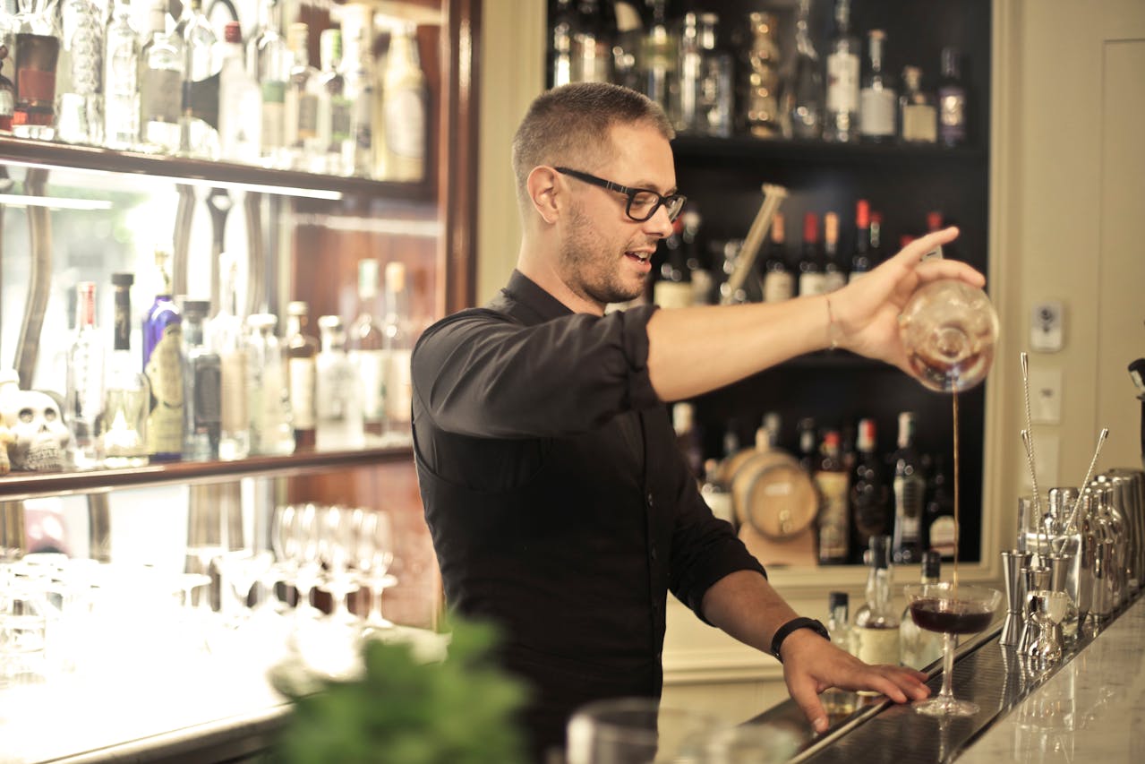 photo of bartender preparing drinks representing Ontario's Working for Workers Four Act, 2024 coming into force